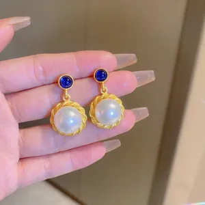 French vintage pearl drop earrings with blue gemstone and gold twisted metal frame