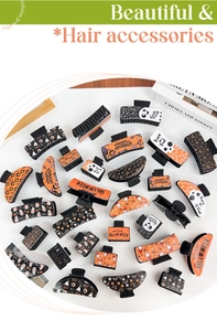 Flat lay of Gothic Halloween hair claws with pumpkin and ghost motifs on white surface
