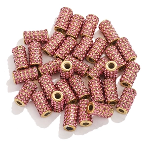 Close-up of sparkling pink rhinestone metal beads for DIY handmade jewelry crafts