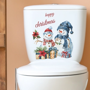 Detail of happy christmas snowman and gift box decals on a white ceramic toilet tank