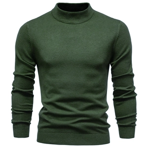 Detailed close-up of dark green men's slim fit knit sweater with ribbed cuffs and hem