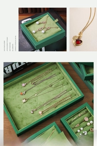 Macro detail of emerald green velvet jewelry display trays with gold luxury necklaces