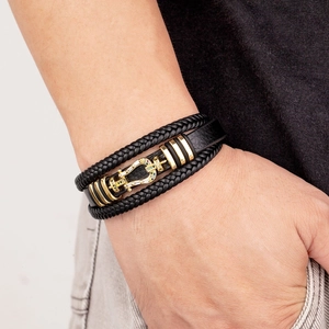 Braided leather bracelet for men featuring a gold horseshoe clasp with zircon inlay