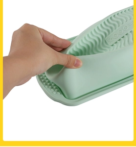 Close-up of flexible green silicone baking brush showing 230°C temperature resistance