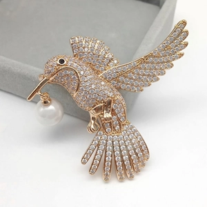 Elegant rose gold hummingbird brooch with sparkling zircons and a white pearl drop