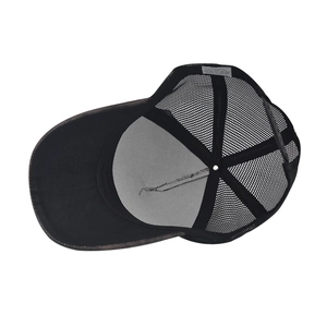 Detail view of cotton baseball cap interior showing the mesh back and care label