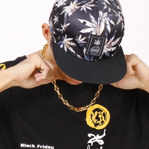 Close-up of hip hop gold chunky link chain necklace worn by male model on black t-shirt