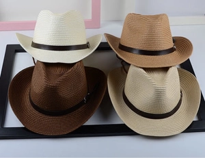 Detailed view of straw cowboy hats in white, beige, khaki and dark coffee with leather bands