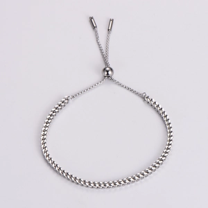 Close-up of adjustable silver woven stainless steel bracelet with slider clasp mechanism