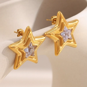 Detailed macro view of 18K gold plated star earrings with sparkling zircon gemstones