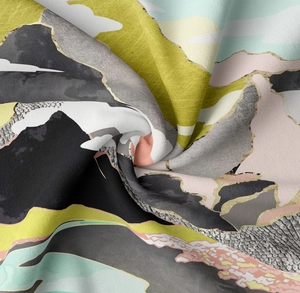 Detailed macro view of digital print fabric with mountain patterns and golden texture