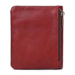 Detail of burgundy leather wallet texture with vintage metal zipper and neat stitching