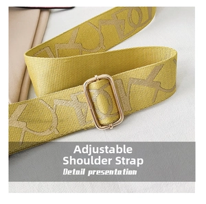 Detail of adjustable yellow strap with golden metal buckle and artistic lettering pattern
