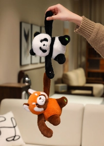 Close-up of plush panda and red panda toys with long magnetic arms for hanging