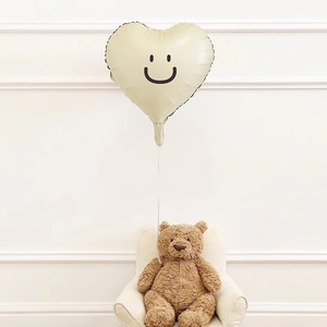 Minimalist beige heart balloon with smiley face design for stylish party decorations