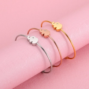 Three minimalist stainless steel elephant bangle set in silver, gold, and rose gold colors