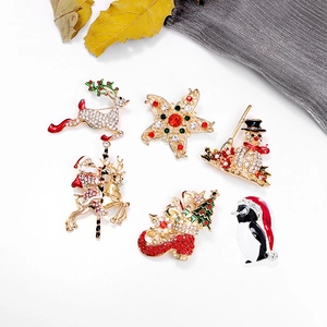 Set of 6 festive Christmas brooches including reindeer, snowman, and Santa on white backdrop