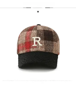 Detailed view of checkered plaid baseball cap with plush brim and embroidered letter R