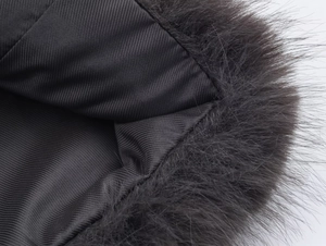 Macro detail of dark grey faux fur collar with premium black ribbed knit lining texture