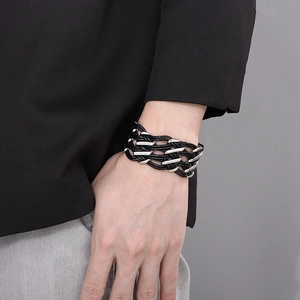 Detailed view of multilayer braided leather bracelet with silver geometric metal accents