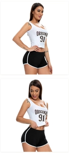 Detail of black sports shorts with white trim and cropped tank top with Original 91 print