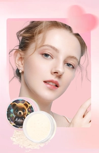 Detailed shot of #05 Mystic loose powder with a cute teddy bear design and heart background