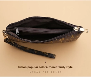 Detail view of the brown leather wristlet showing three-tier internal compartments and zipper