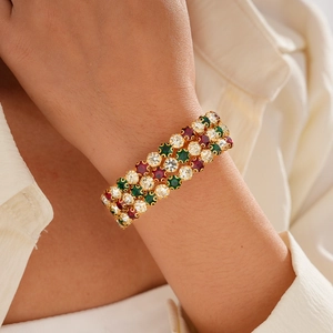 Luxury three-row retro bangle with red, green, and clear crystals in gold setting