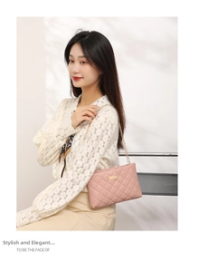 Pink quilted crossbody chain bag shown on a model against a soft shadow background