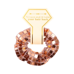 Detailed shot of rose gold scrunchie with square sequins and card packaging