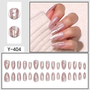 Cat eye almond press-on nails with golden leaf patterns and pearl pink finish