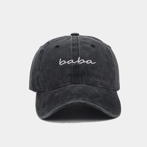 Détail de la broderie baba blanche sur une casquette de baseball vintage gris foncé lavé