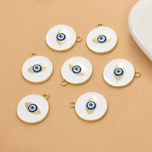 Detailed macro shot of seven round gold enamel evil eye pendants for jewelry making