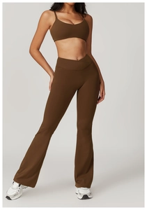 Detail of dark brown sports bra and flared yoga pants set with crossover waist design