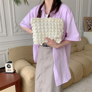 Portable cream white bubble cloud makeup bag with quilted texture and handle