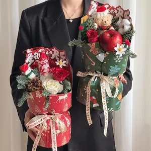 Chic Christmas flower bouquet set with roses and festive ornaments in gift wrap