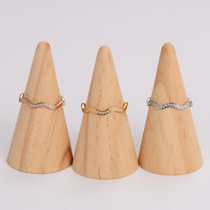 Micro-pave wave rings in gold silver and rose gold on wooden display stands