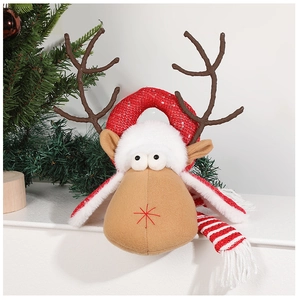 Detail of plush Christmas reindeer ornament with red sequin headband and striped scarf