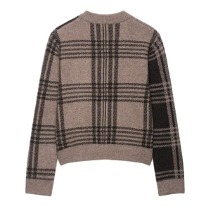 Detail view of the back of a plaid knit sweater showing the brown checkered texture