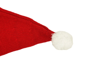 Gros plan sur la texture du bonnet de Noël tricoté rouge avec pompon blanc