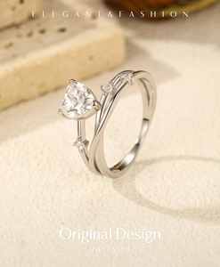 Detail of silver S925 heart-cut moissanite ring with elegant crossover diamond band