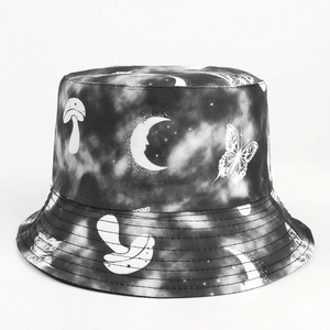 Detail of tie-dye bucket hat featuring butterfly, moon, and mushroom pattern prints