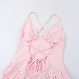 Detailed back view of pink romper featuring crisscross straps and delicate lace ruffles