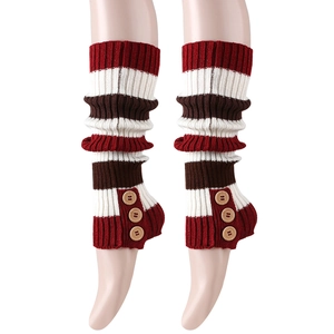 Detail of knit leg warmers featuring red, white and dark coffee stripes with wood buttons