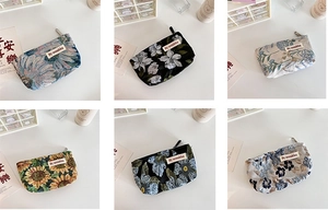 Multiple French-style floral embossed makeup bags with vintage jacquard patterns