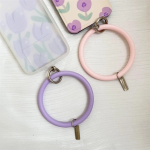 Detailed view of soft pink and purple silicone phone wrist straps with silver metal clasps