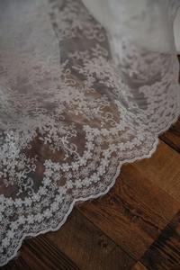 Macro shot of delicate white lace fabric with floral patterns for cake photography