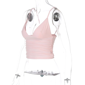 Detailed view of pink V-neck crop top featuring thin straps and side ruched textures