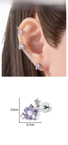 Macro detail of star-shaped stud earrings in purple and pink with size dimensions