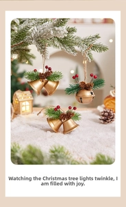 Close-up of golden Christmas bells with pine needles, red berries and rustic hemp rope
